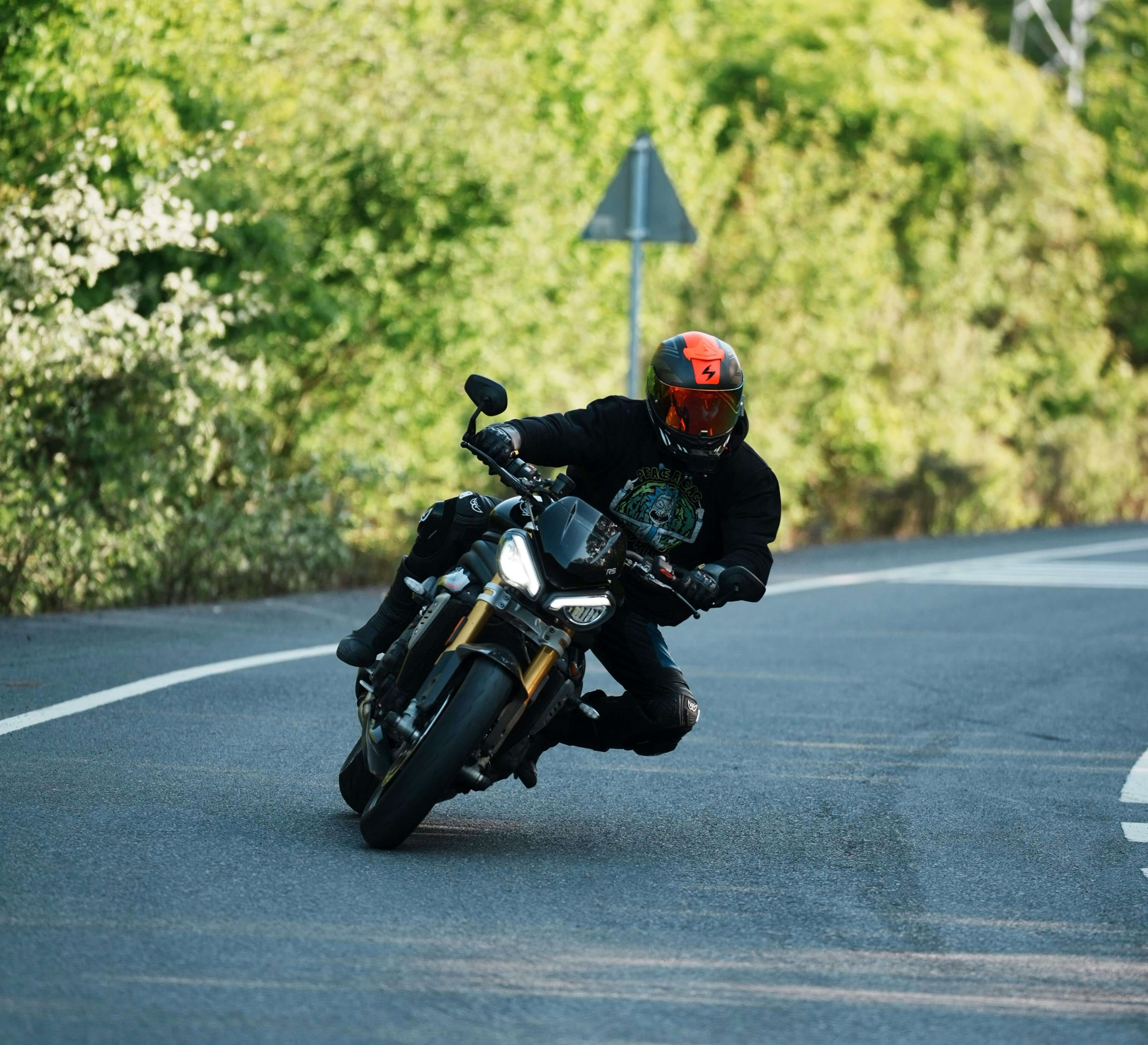 Motorcycle on a road through mountain meadows.